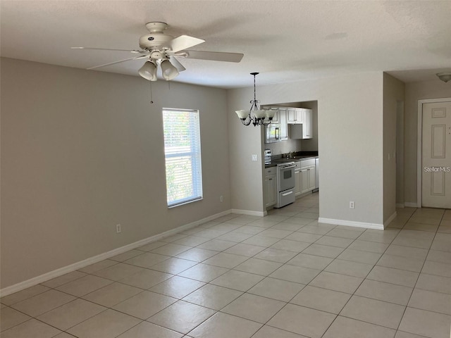 1491 Capricorn Blvd, Punta Gorda, FL 33983 - unfurnished dining area featuring a ceiling fan, a chandelier, and light tile patterned floors