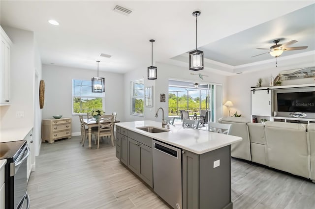 13416 Trascoro Ln, Port Charlotte, FL 33981 - kitchen featuring stainless steel appliances, open floor plan, ceiling fan, light wood-type flooring, and gray cabinets