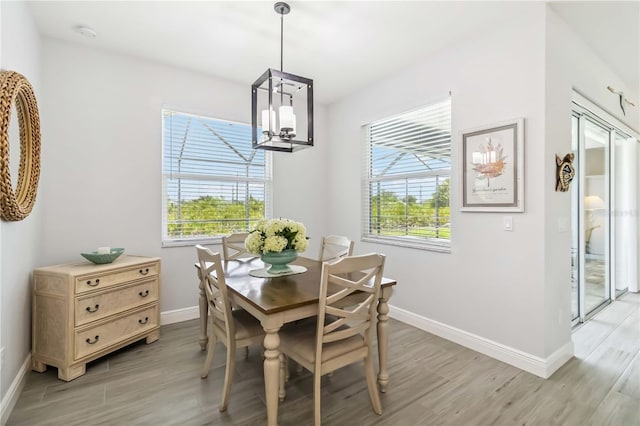 13416 Trascoro Ln, Port Charlotte, FL 33981 - dining space featuring light wood finished floors, plenty of natural light, and a chandelier