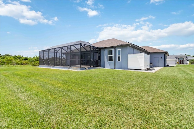 13416 Trascoro Ln, Port Charlotte, FL 33981 - back of house featuring a yard, stucco siding, and glass enclosure