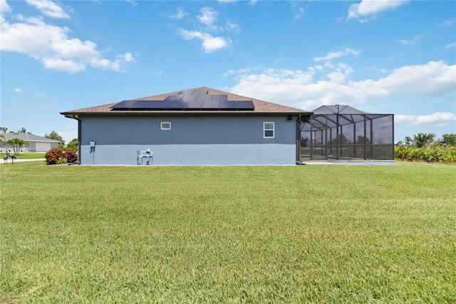 13416 Trascoro Ln, Port Charlotte, FL 33981 - back of house with a lawn, solar panels, stucco siding, and a lanai