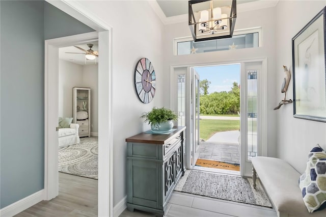 13416 Trascoro Ln, Port Charlotte, FL 33981 - entryway with ornamental molding, a chandelier, ceiling fan, and wood finished floors