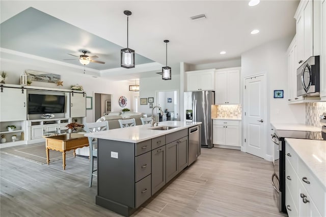 13416 Trascoro Ln, Port Charlotte, FL 33981 - kitchen with stainless steel appliances, open floor plan, white cabinets, tasteful backsplash, and recessed lighting
