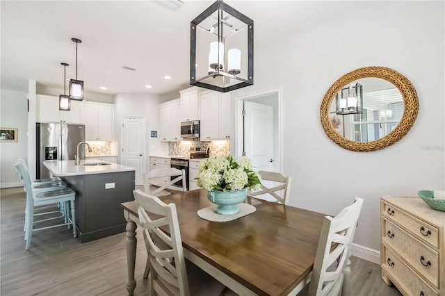 13416 Trascoro Ln, Port Charlotte, FL 33981 - dining area featuring wood finished floors, a chandelier, and recessed lighting