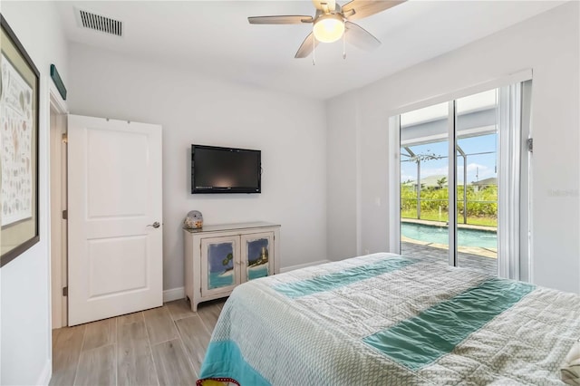 13416 Trascoro Ln, Port Charlotte, FL 33981 - bedroom featuring access to outside, light wood-style flooring, and a ceiling fan
