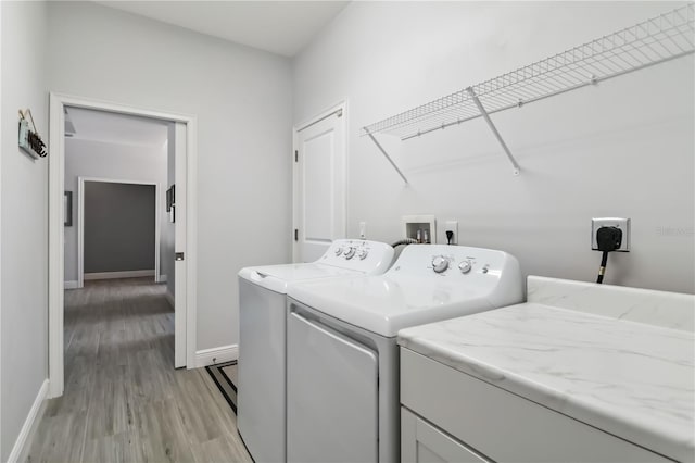 13416 Trascoro Ln, Port Charlotte, FL 33981 - washroom with washer and clothes dryer and light wood-type flooring