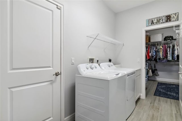 13416 Trascoro Ln, Port Charlotte, FL 33981 - washroom featuring separate washer and dryer and light wood-type flooring