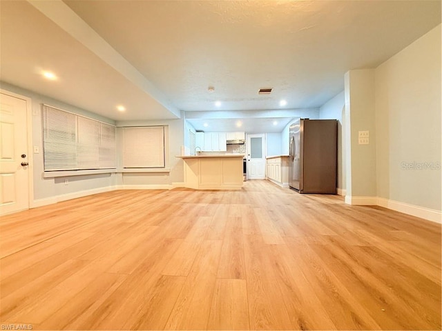 3902 Locust Ave, Sarasota, FL 34234 - unfurnished living room with light wood-style flooring and recessed lighting