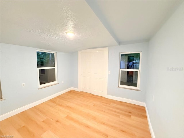3902 Locust Ave, Sarasota, FL 34234 - unfurnished bedroom featuring a textured ceiling, light wood-type flooring, and a closet