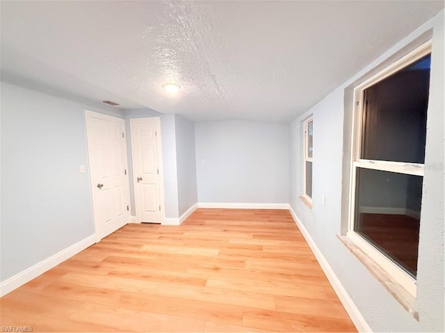 3902 Locust Ave, Sarasota, FL 34234 - unfurnished room featuring light wood-style flooring and a textured ceiling