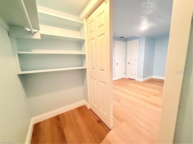 3902 Locust Ave, Sarasota, FL 34234 - hallway with baseboards and wood finished floors