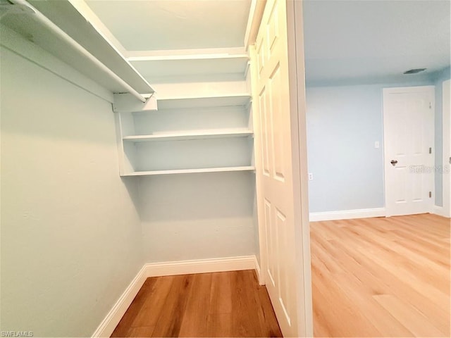 3902 Locust Ave, Sarasota, FL 34234 - walk in closet featuring wood finished floors