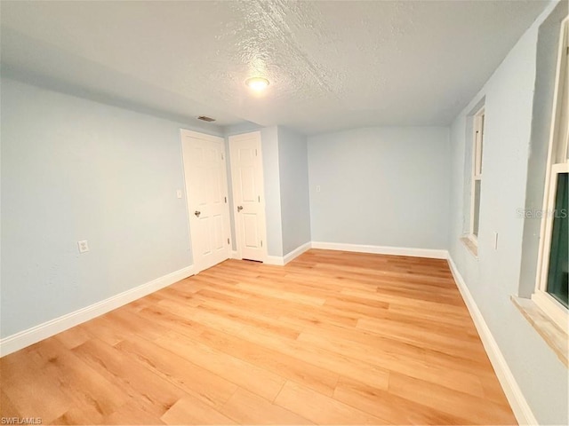3902 Locust Ave, Sarasota, FL 34234 - empty room featuring a textured ceiling and light wood-type flooring