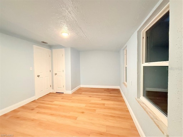 3902 Locust Ave, Sarasota, FL 34234 - spare room with a textured ceiling and light wood finished floors
