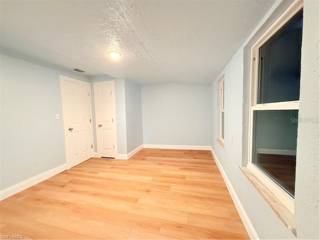 3902 Locust Ave, Sarasota, FL 34234 - empty room featuring light wood-type flooring and a textured ceiling