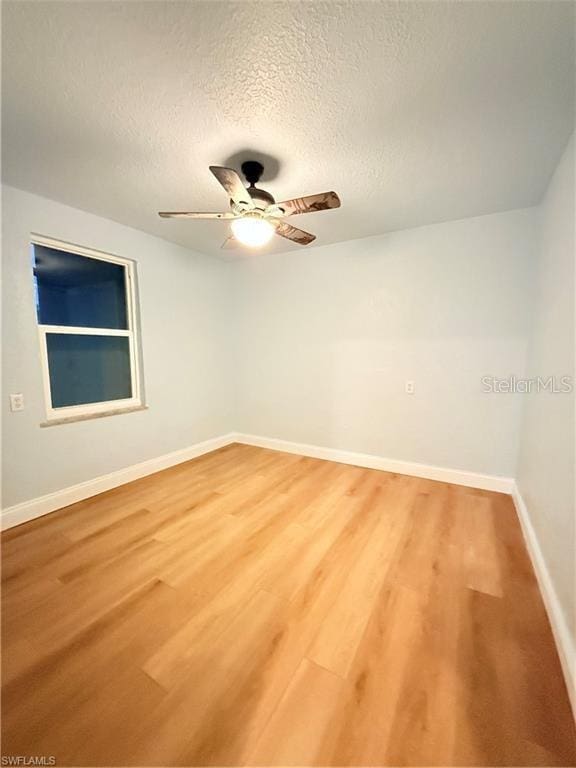 3902 Locust Ave, Sarasota, FL 34234 - empty room with a ceiling fan, a textured ceiling, and light wood-style flooring