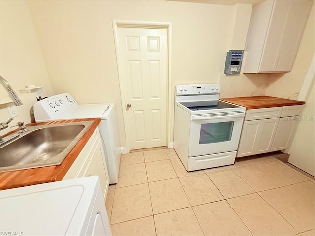 3902 Locust Ave, Sarasota, FL 34234 - kitchen featuring white electric stove, washer / dryer, light tile patterned floors, and white cabinets