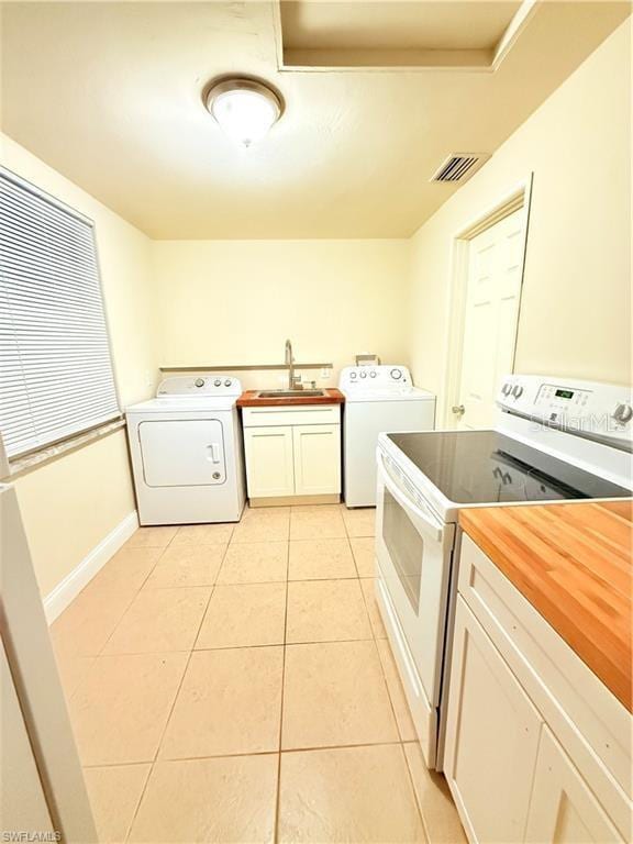 3902 Locust Ave, Sarasota, FL 34234 - laundry area with light tile patterned floors and hookup for a washing machine