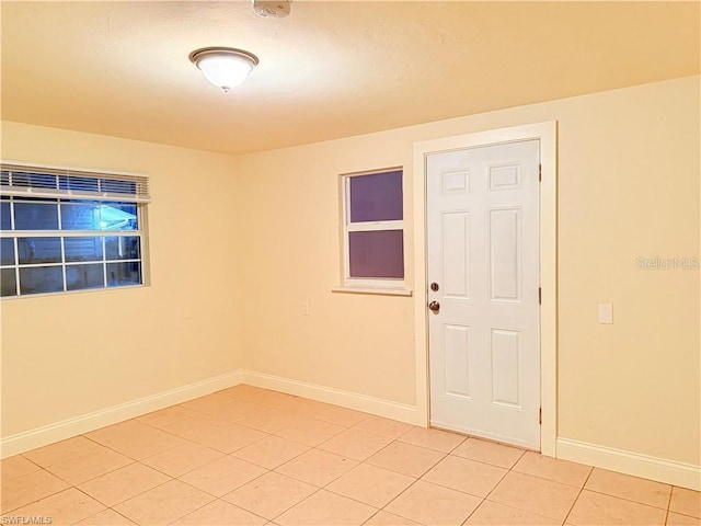 3902 Locust Ave, Sarasota, FL 34234 - unfurnished room featuring light tile patterned floors and baseboards