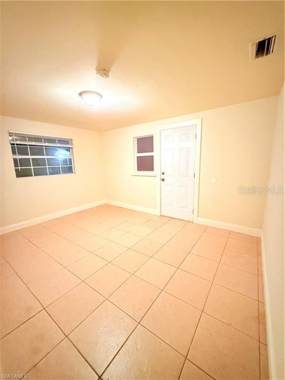 3902 Locust Ave, Sarasota, FL 34234 - empty room with light tile patterned flooring and a smoke detector