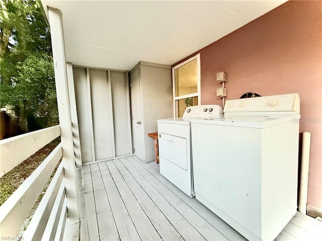 3902 Locust Ave, Sarasota, FL 34234 - laundry area featuring washer and clothes dryer and light wood-style floors