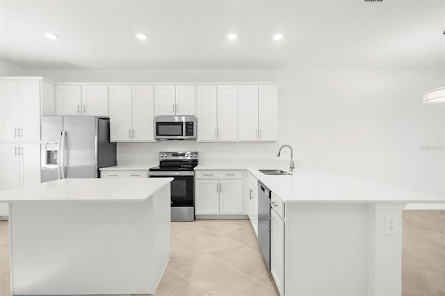 17565 Opal Sand Dr Unit 403, Venice, FL 34293 - kitchen with stainless steel appliances, light countertops, a peninsula, white cabinets, and recessed lighting