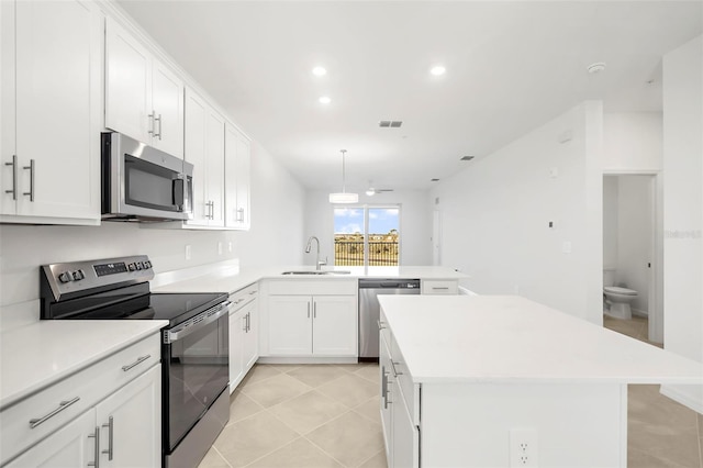 17565 Opal Sand Dr Unit 403, Venice, FL 34293 - kitchen featuring appliances with stainless steel finishes, a peninsula, light countertops, a kitchen island, and recessed lighting