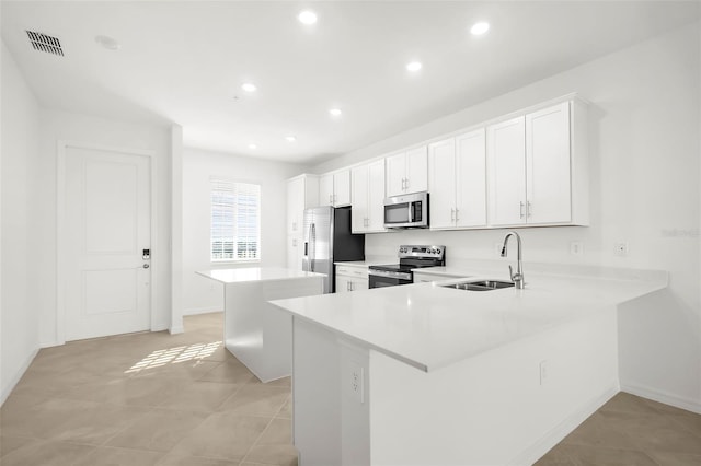 17565 Opal Sand Dr Unit 403, Venice, FL 34293 - kitchen featuring stainless steel appliances, a kitchen island, light countertops, recessed lighting, and white cabinets