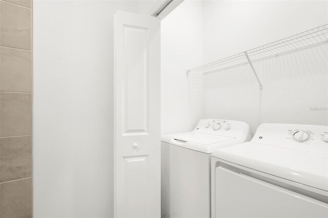17565 Opal Sand Dr Unit 403, Venice, FL 34293 - laundry area featuring washing machine and clothes dryer