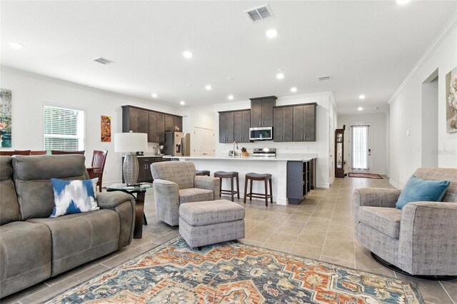 2456 Nabble Ln, North Port, FL 34288 - living area featuring ornamental molding, healthy amount of natural light, recessed lighting, and light tile patterned floors