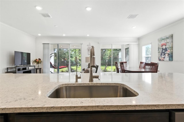 2456 Nabble Ln, North Port, FL 34288 - kitchen with open floor plan, light stone counters, ornamental molding, and recessed lighting