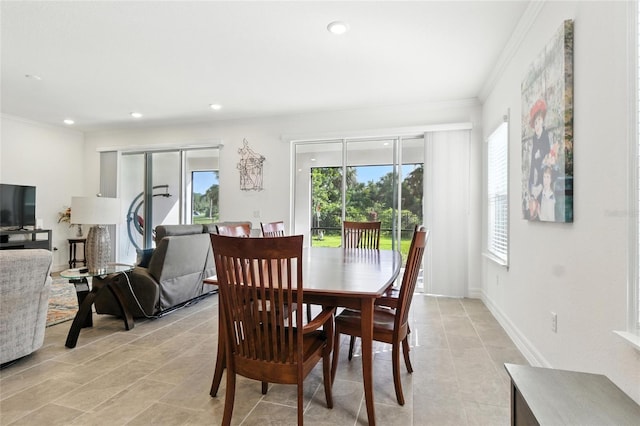 2456 Nabble Ln, North Port, FL 34288 - dining room with healthy amount of natural light, ornamental molding, light tile patterned flooring, and recessed lighting
