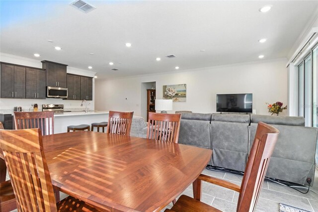2456 Nabble Ln, North Port, FL 34288 - dining area with ornamental molding, recessed lighting, and light tile patterned floors
