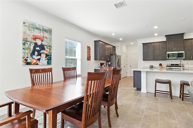 2456 Nabble Ln, North Port, FL 34288 - dining room with ornamental molding, recessed lighting, and light tile patterned flooring