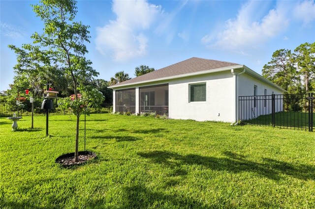 2456 Nabble Ln, North Port, FL 34288 - rear view of property featuring stucco siding and a sunroom
