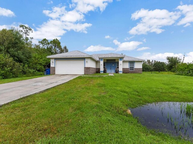 9761 Councilor Ln, North Fort Myers, FL 33917 - view of front facade with a garage, brick siding, concrete driveway, a front yard, and a metal roof