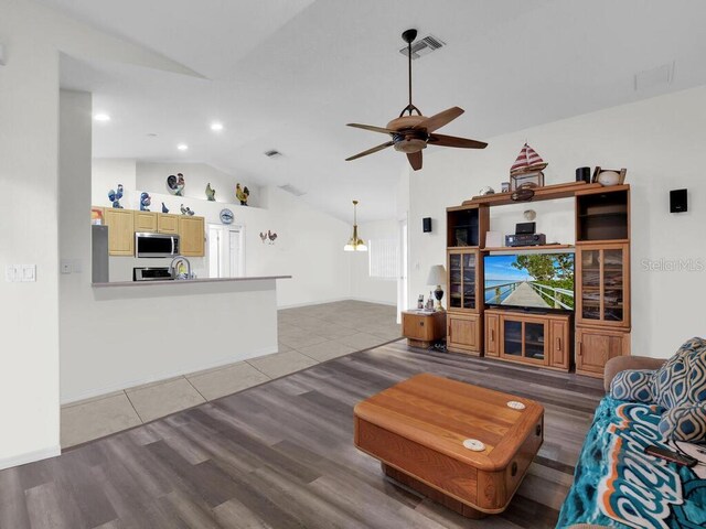 9761 Councilor Ln, North Fort Myers, FL 33917 - living area featuring lofted ceiling, wood finished floors, a ceiling fan, and recessed lighting