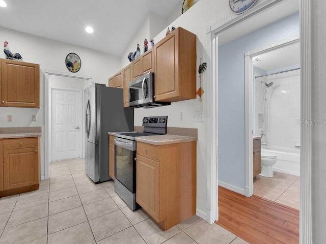 9761 Councilor Ln, North Fort Myers, FL 33917 - kitchen with stainless steel appliances, light countertops, light tile patterned flooring, and recessed lighting
