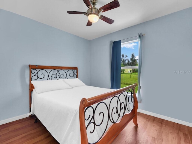 9761 Councilor Ln, North Fort Myers, FL 33917 - bedroom featuring wood finished floors and ceiling fan