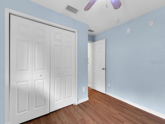9761 Councilor Ln, North Fort Myers, FL 33917 - unfurnished bedroom featuring wood finished floors, a closet, and a ceiling fan