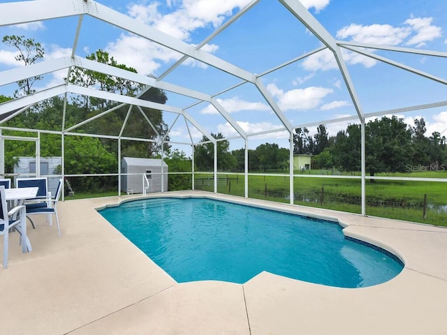 9761 Councilor Ln, North Fort Myers, FL 33917 - swimming pool featuring a patio, a storage unit, and view of scattered trees