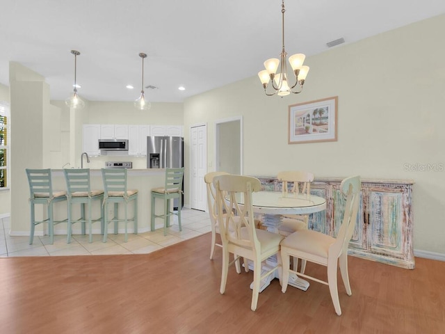 2040 Embarcadero Way N, Fort Myers, FL 33917 - dining room featuring a chandelier, light wood-style flooring, and recessed lighting