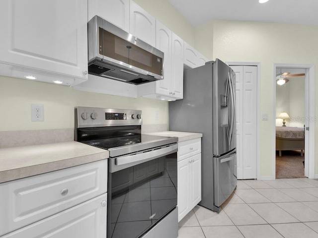 2040 Embarcadero Way N, Fort Myers, FL 33917 - kitchen with stainless steel appliances, white cabinets, light countertops, light tile patterned floors, and a ceiling fan