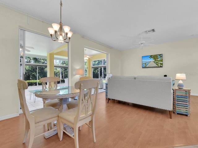 2040 Embarcadero Way N, Fort Myers, FL 33917 - dining area featuring a ceiling fan, light wood-style floors, and a chandelier