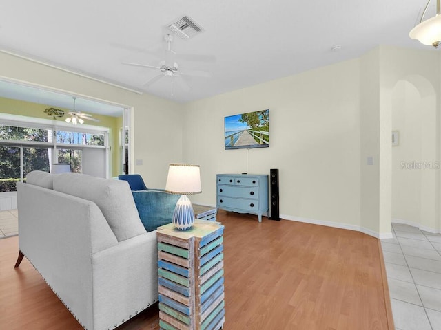 2040 Embarcadero Way N, Fort Myers, FL 33917 - living room with a ceiling fan, arched walkways, and light wood-style floors