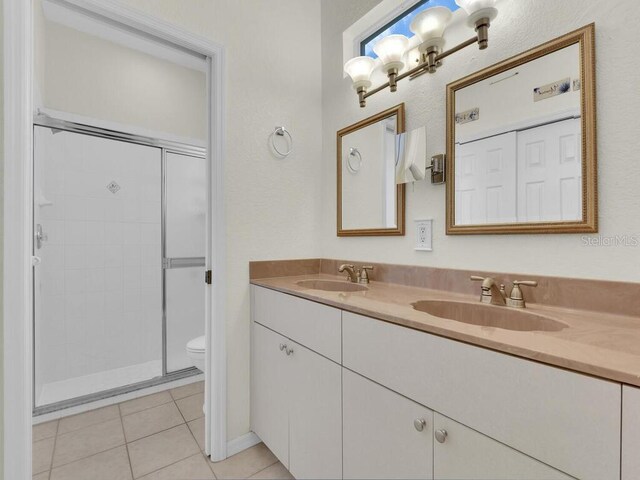 2040 Embarcadero Way N, Fort Myers, FL 33917 - bathroom with double vanity, a shower stall, and tile patterned flooring