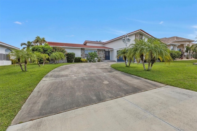 16 Tropicana Dr, Punta Gorda, FL 33950 - ranch-style house featuring concrete driveway, a tile roof, a front lawn, stucco siding, and a garage