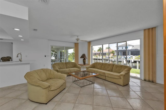 16 Tropicana Dr, Punta Gorda, FL 33950 - living room featuring a water view, light tile patterned floors, a ceiling fan, and recessed lighting