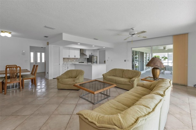 16 Tropicana Dr, Punta Gorda, FL 33950 - living room featuring a textured ceiling, light tile patterned floors, and ceiling fan