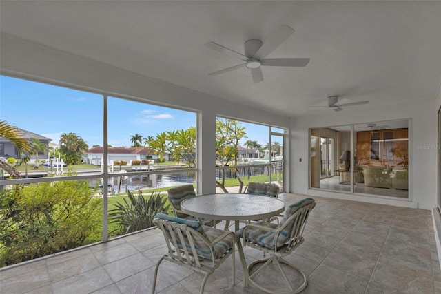 16 Tropicana Dr, Punta Gorda, FL 33950 - sunroom / solarium with a ceiling fan, a water view, a residential view, and outdoor dining space